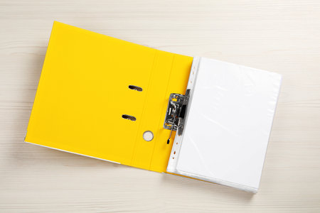 Open office folder on white wooden table, top viewの写真素材