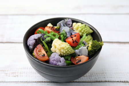 Delicious salad with cauliflower and tomato on white wooden table, closeupの写真素材