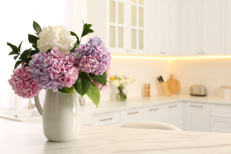 Bouquet with beautiful hydrangea flowers on white marble table. Space for textの写真素材