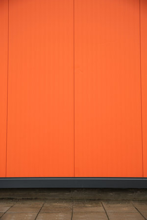 Beautiful orange wall and stone pavement outdoorsの写真素材