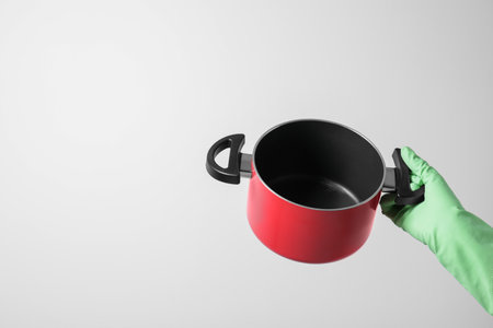 Woman holding empty pot on white background, closeup. Space for textの写真素材