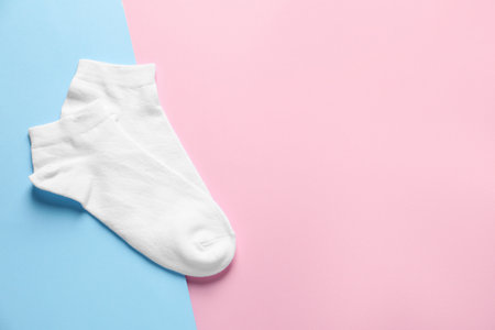 Pair of white socks on colorful background, flat lay. Space for textの写真素材