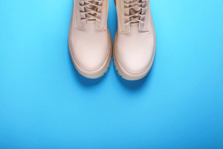 Pair of stylish leather shoes on light blue background, flat lay. Space for textの写真素材