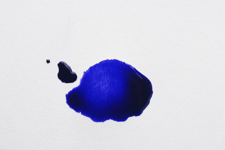 Blot of blue ink on white background, top viewの写真素材
