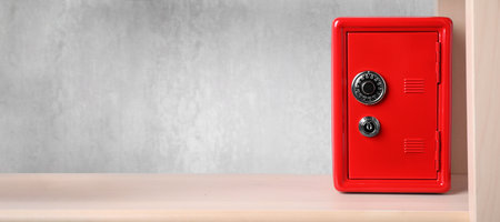 Red steel safe with mechanical combination lock on shelf, banner design. Space for textの写真素材