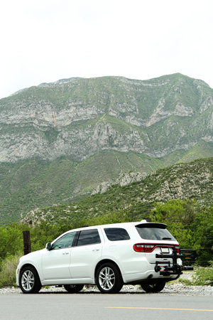 Beautiful view of mountains and car on roadside outdoors. Road tripの写真素材