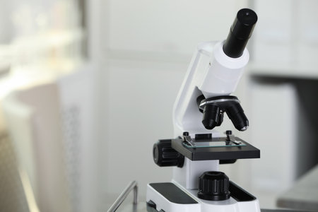 Modern medical microscope on blurred background, closeup with space for text. Laboratory equipmentの写真素材