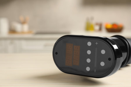 Thermal immersion calculator on white table in kitchen, closeup with space for text.の写真素材