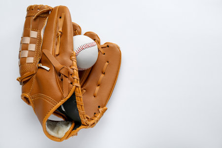 Catcher's mitt and baseball ball on white background, top view with space for text. Sports gameの写真素材