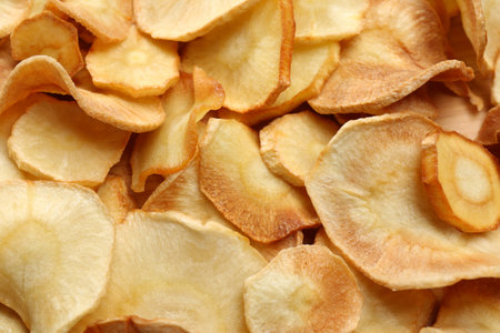 Tasty homemade parsnip chips as background, top viewの写真素材