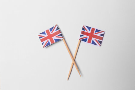 Small paper flags of United Kingdom on light background, flat layの写真素材