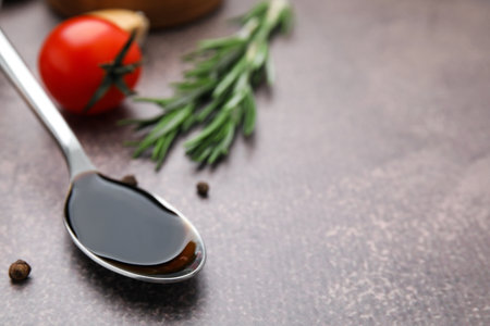 Organic balsamic vinegar and cooking ingredients on gray table, closeup. Space for textの写真素材