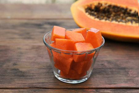 Tasty cut papaya fruits on wooden table, closeupの写真素材