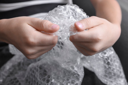 Boy popping   wrap indoors, closeup. stress reliefの写真素材