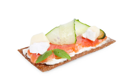 Tasty rye crispbread with salmon, cream cheese and cucumber isolated on whiteの写真素材