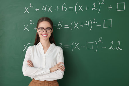 Portrait of young math's teacher near chalkboard