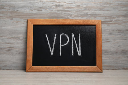 Chalkboard with acronym VPN on wooden tableの写真素材