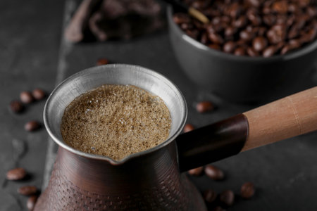 Cezve with Turkish coffee on dark gray table, closeupの写真素材