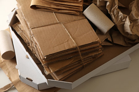 Stack of different waste paper on beige background, closeupの写真素材