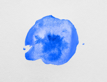 Blot of light blue ink on white background, top viewの写真素材
