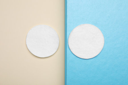 Clean cotton pads on color background, flat layの写真素材