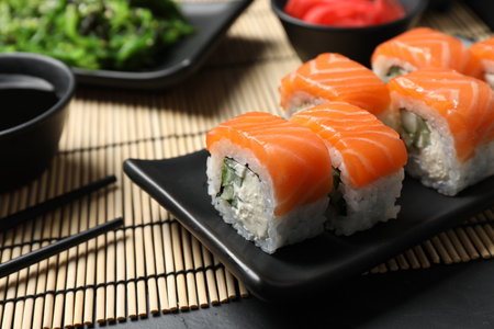 Tasty sushi rolls served on black table, closeupの写真素材