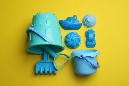 Beach sand toy kit on yellow background, flat layの写真素材