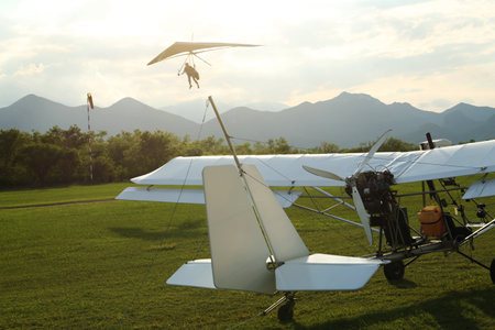 Modern white airplane on green grass outdoors