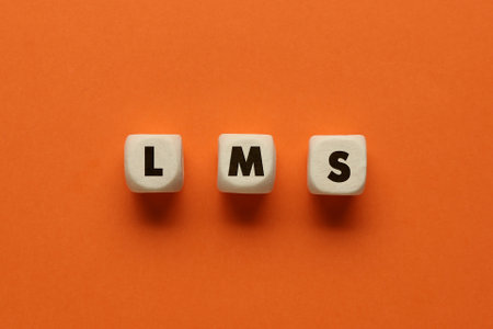 learning management system. Wooden cubes with abbreviation LMS on orange background, top viewの写真素材