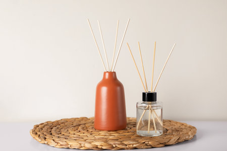 Aromatic reed air fresheners on white table