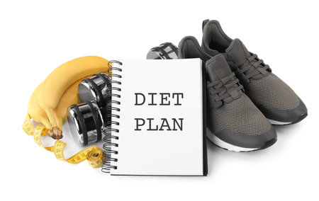 Notebook with phrase Diet Plan, fitness items and bananas on white background. weight loss programの写真素材