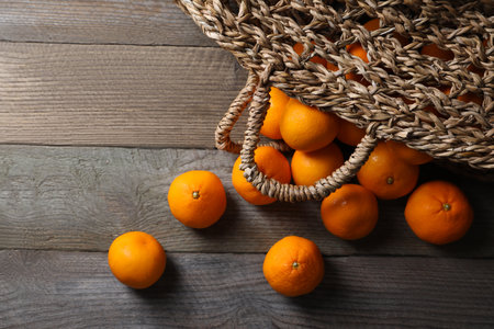 Many fresh ripe tangerines on wooden table, flat layの写真素材