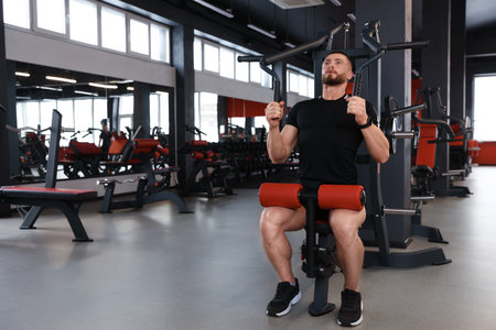 Man training with professional machine in gym