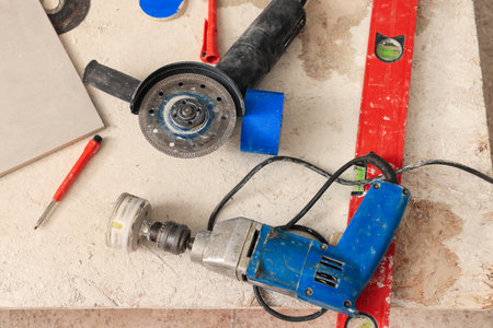 Buffing attachment drill and saw on chipboard indoors. Tiles installation processの写真素材