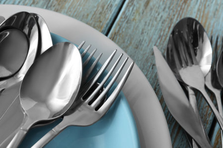 Different clean kitchenware on old light blue wooden table, flat layの写真素材