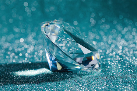 Beautiful dazzling diamond on shiny glitter background, closeup. Precious gemstoneの写真素材