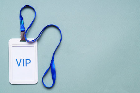 Plastic vip badge on light background, top view. Space for text