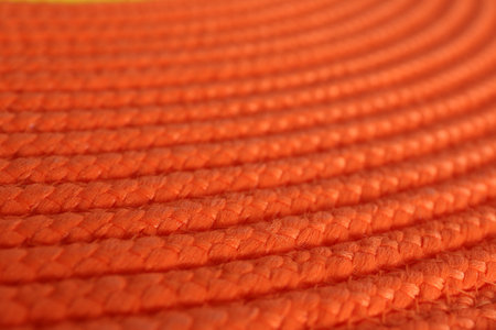 Texture of orange wicker mat as background, closeup viewの写真素材