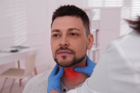 endocrine system. Doctor examining patient's thyroid gland in hospital