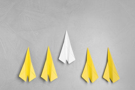 Flat lay composition with paper planes on light gray table. Space for textの写真素材