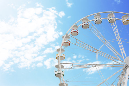 Large white observation wheel against sky, space for textの写真素材
