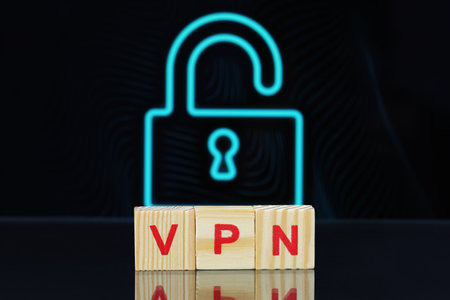 Acronym VPN (Virtual Private Network) made of wooden cubes on dark background with lockの写真素材