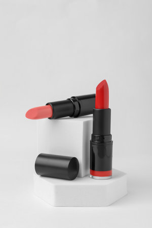 Different beautiful glossy lipsticks on white backgroundの写真素材