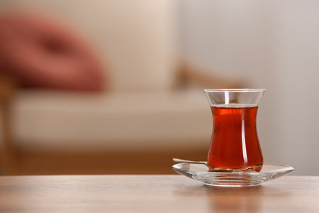Glass with tasty Turkish tea on wooden table indoors, space for textの写真素材