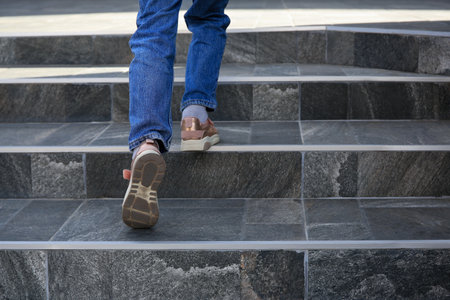 Woman walking up stylish stone stairs outdoors, closeupの写真素材