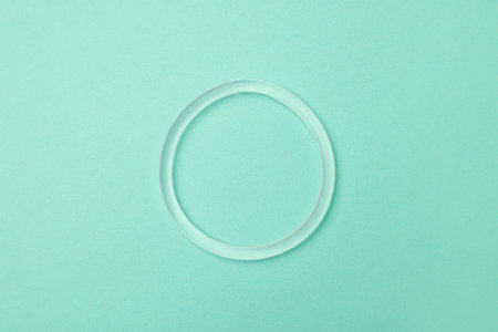 Diaphragm vaginal contraceptive ring on turquoise background, top viewの写真素材