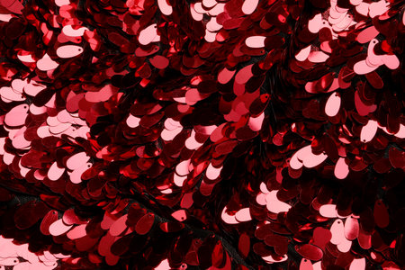 Closeup view of red shiny sequin fabric as backgroundの写真素材