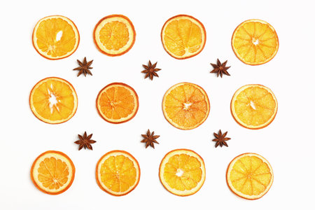 Flat lay composition with dry orange slices and anise stars on white background