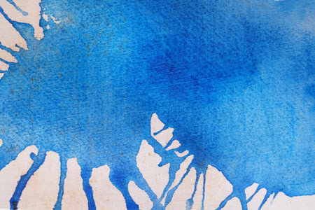Abstract blue watercolor painting on white paper, top viewの写真素材