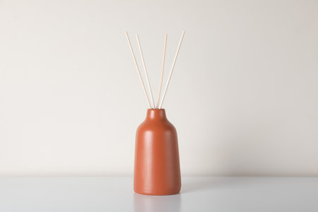 Aromatic reed air freshener on white table